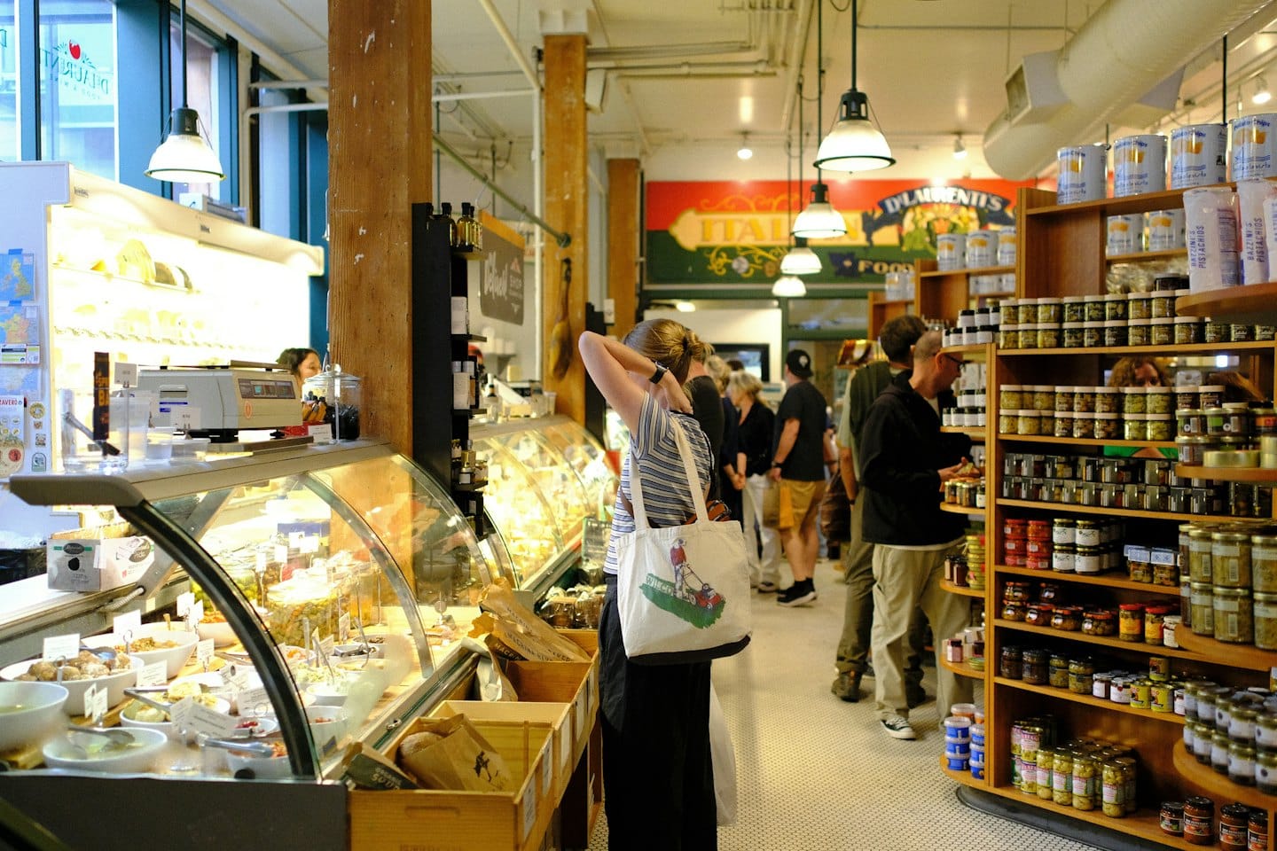 Customers shop for food inside a busy specialty market.
