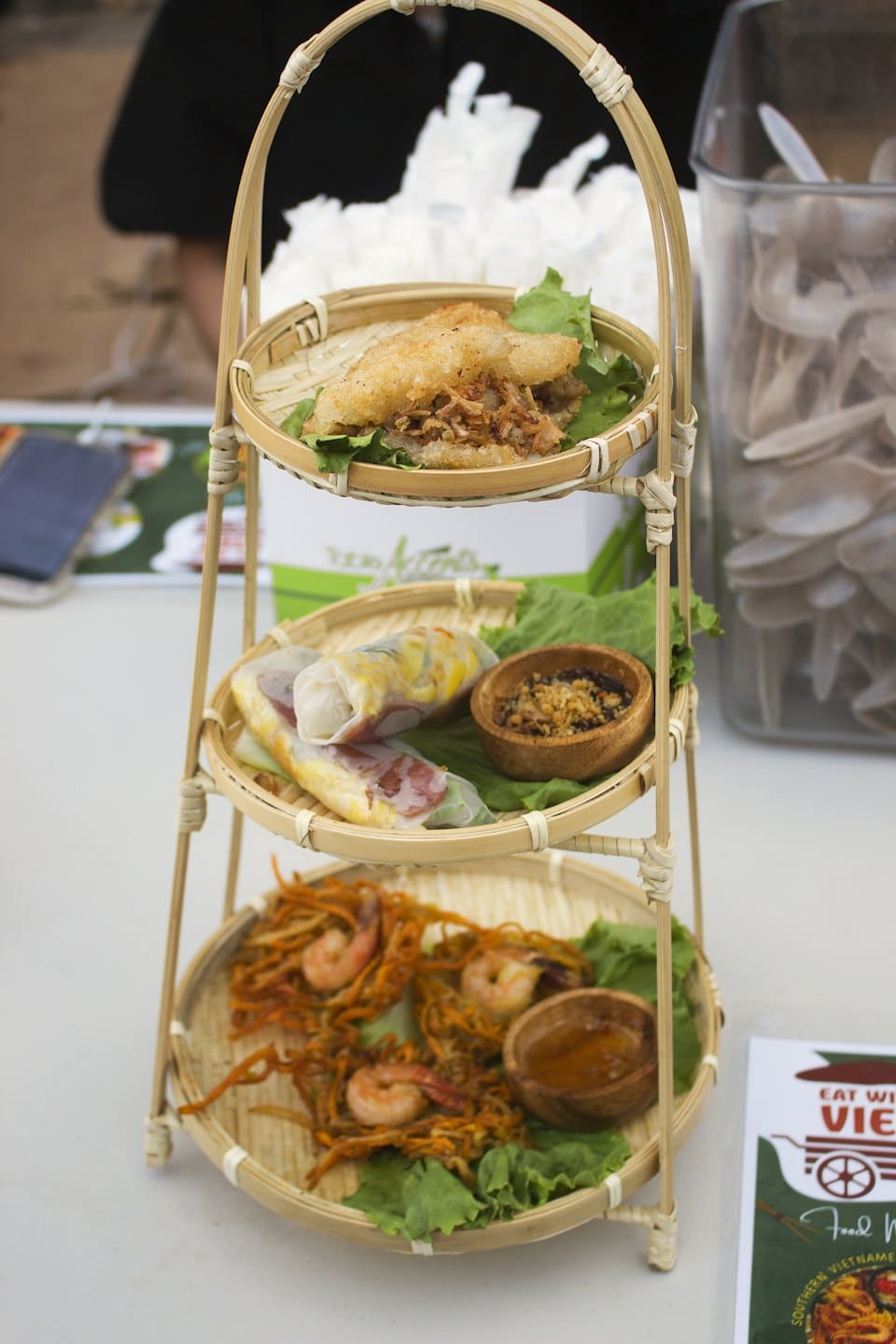 Vietnamese dishes served on a three-tiered bamboo stand.