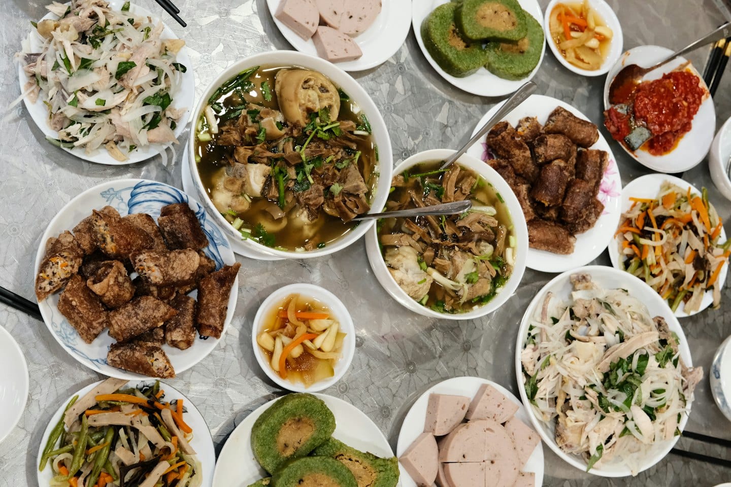 A variety of Vietnamese dishes arranged on a table.